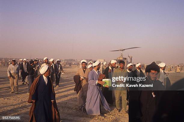 Clergymen arrive at a makeshift heliport before attending the funeral of Ayatollah Khomeini at Behesht Zahra cemetery, Tehran, Iran, 6th June 1989.