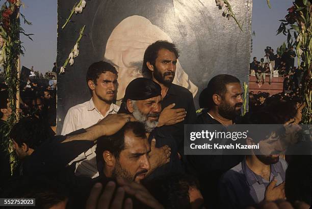 Thousands of people gathered for the funeral of Ayatollah Khomeini beating themselves on the chest and head at his final resting place near Behesht...
