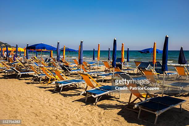 longchairs in alassio beach (italia) - farniente stockfoto's en -beelden