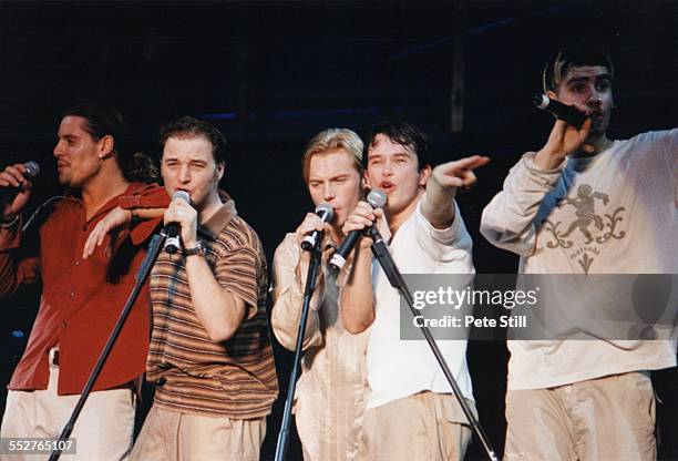 Keith Duffy, Mikey Graham, Ronan Keating and Stephen Gately of Boyzone perform on stage at Battersea Power Station, on December 13th, 1997 in London,...