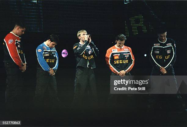 Keith Duffy, Stephen Gately, Ronan Keating, Mikey Graham and Shane Lynch of Boyzone perform on stage at the National Exhibition Centre, on December...