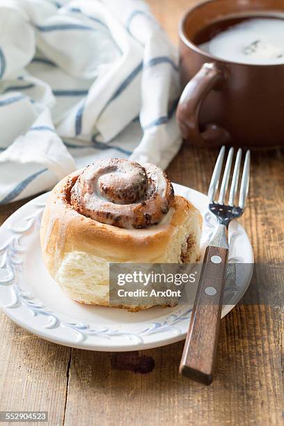 cinnamon bun with cup of coffee, breakfast in cafe - coffee cake stock pictures, royalty-free photos & images