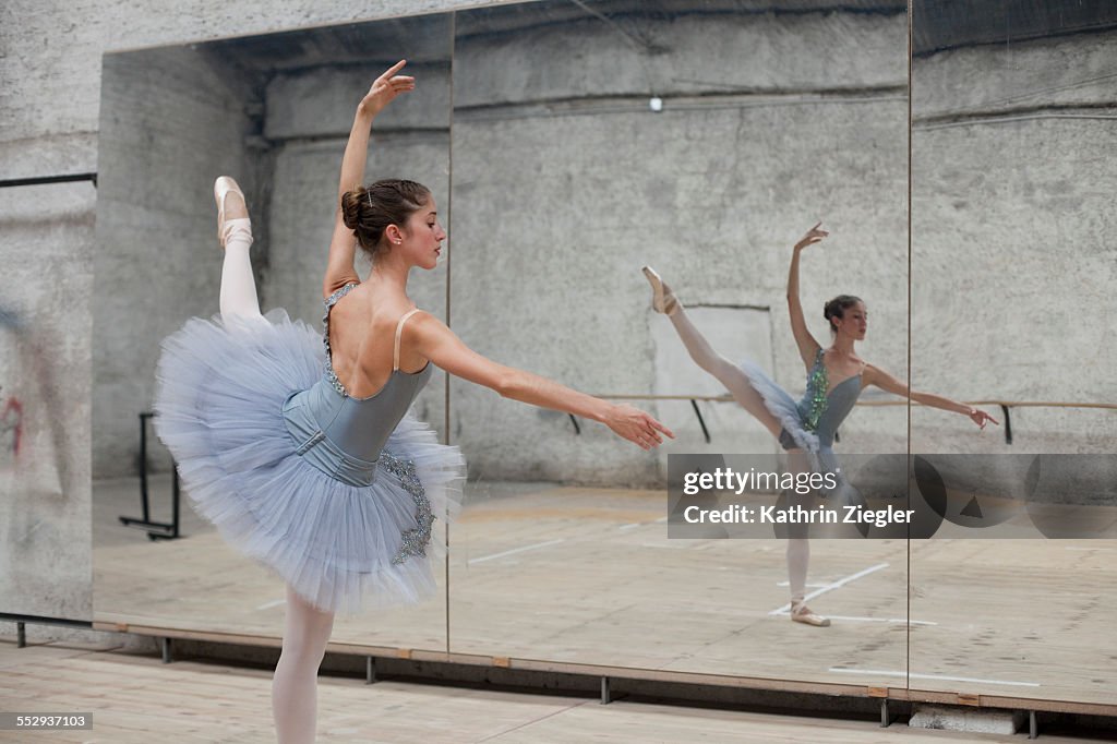 Ballerina exercising in front of mirror