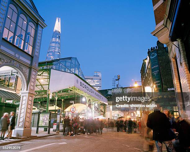 people enjoying a drink outside borough market - borough market stock pictures, royalty-free photos & images