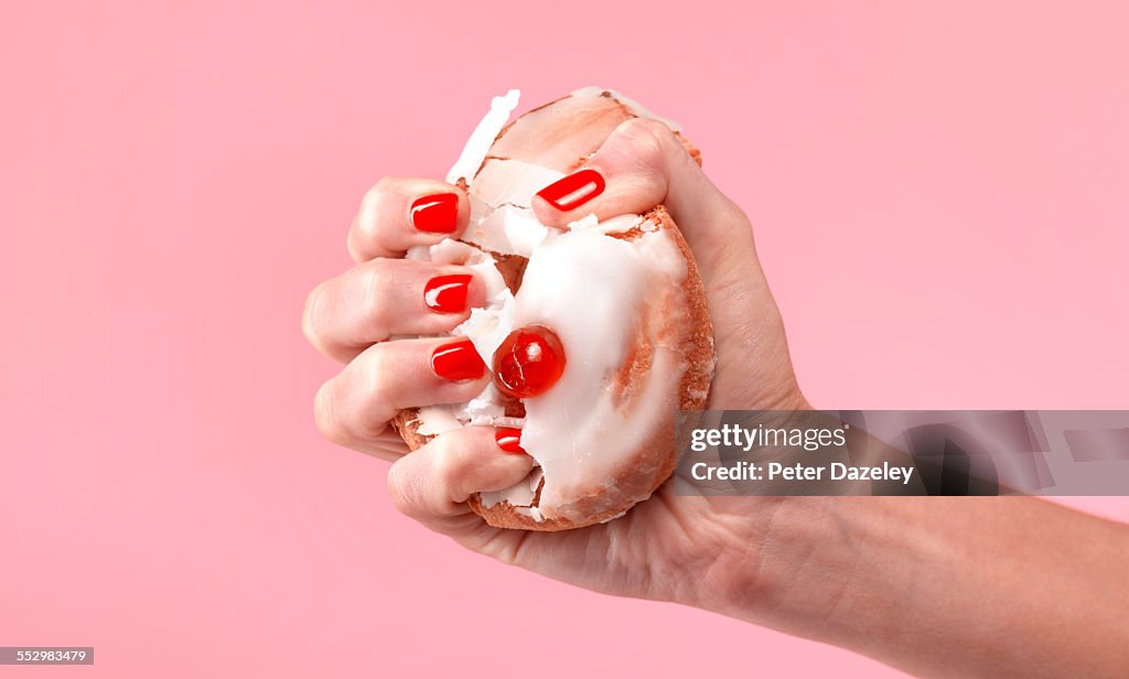 Female dieter crushing belgian bun