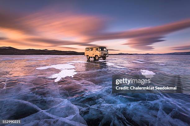 car on ice at lake baikal - baikal stockfoto's en -beelden