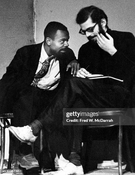 American poets LeRoi Jones and Allen Ginsberg converse on stage during poetry reading at the Living Theatre, New York, New York, November 2, 1959.