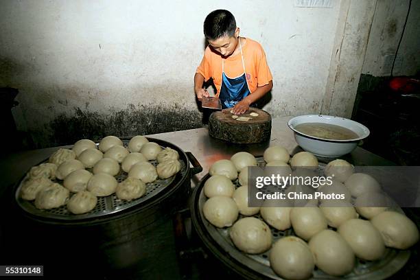 Student prepares meat at a cooking school on August 29, 2005 in Lantian County of Shaanxi Province, China. Most students at the school are teenages,...