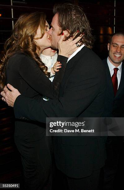 Actress Brooke Shields kisses her husband, writer Chris Henchy as daughter Rowan looks on during Shields's 40th birthday celebration at the Mint Leaf...