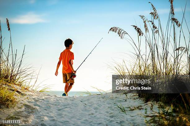 youth asian boy fishing at the beach at sunset. - costa del golfo degli stati uniti d'america foto e immagini stock