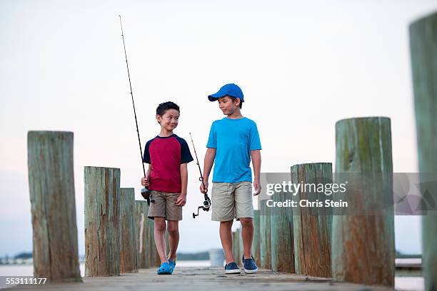 young asian brothers on a fishing pier - saia florida stock-fotos und bilder