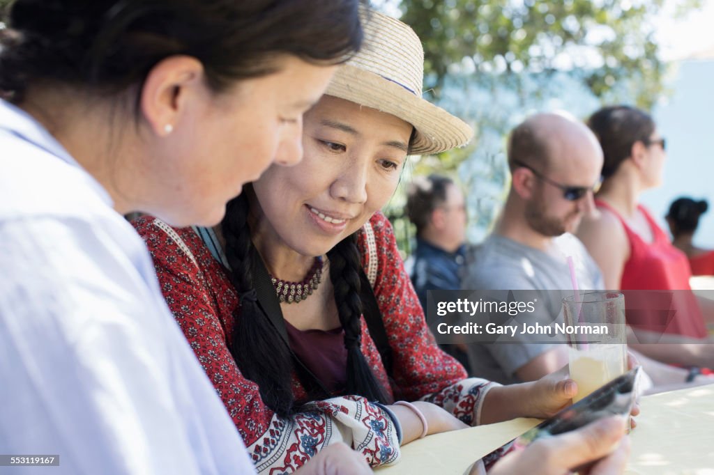 Tourists relaxing with a drink at a cafe, Cuba