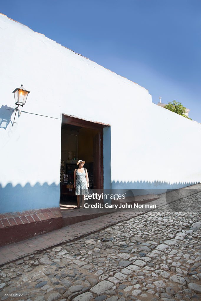 Tourist standing in doorway,Trinidad, Cuba