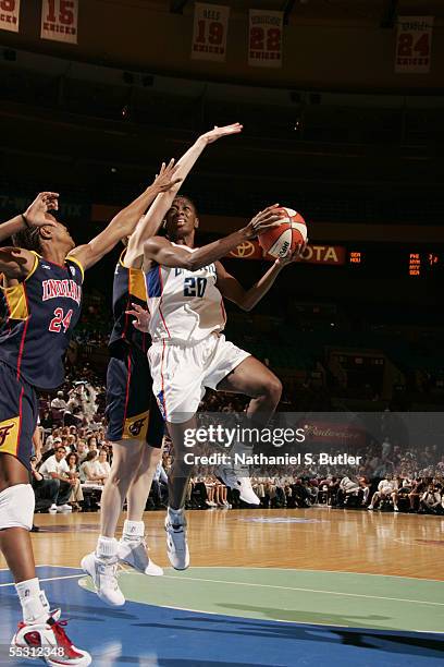 Shameka Christon of the New York Liberty lays a shot up over Tamika Catchings of the Indiana Fever in Game One of the first round of the Eastern...