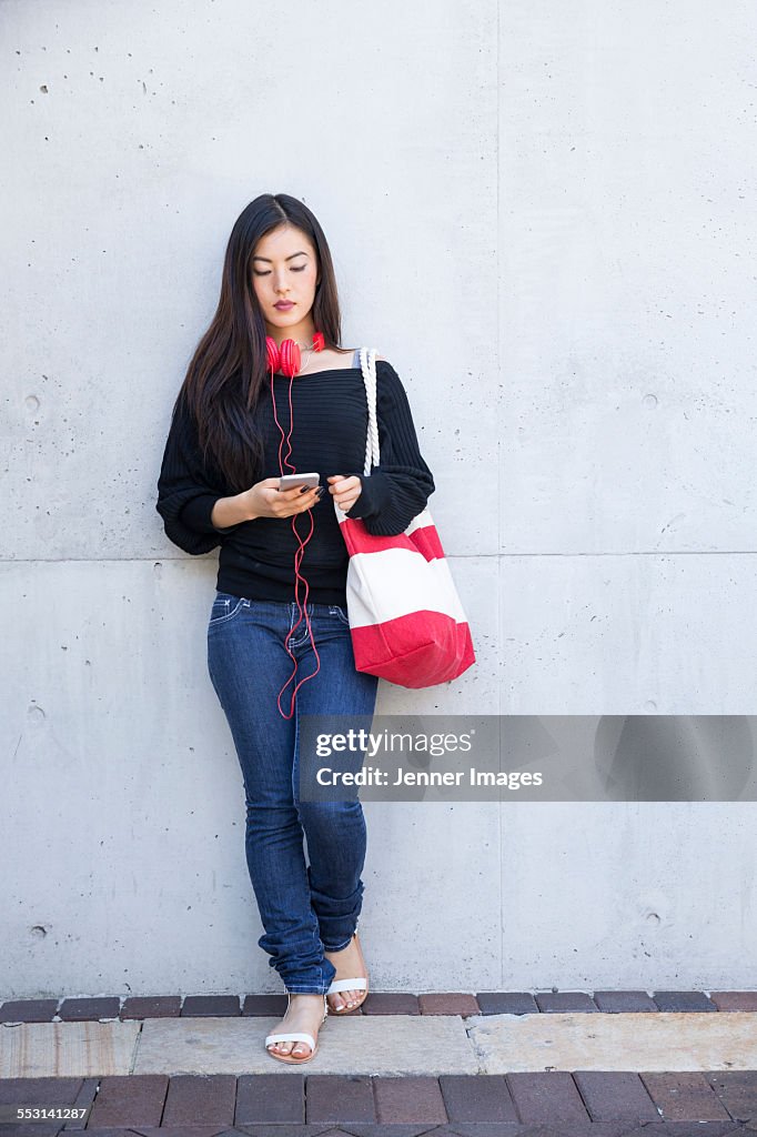 Asian woman using smart phone.