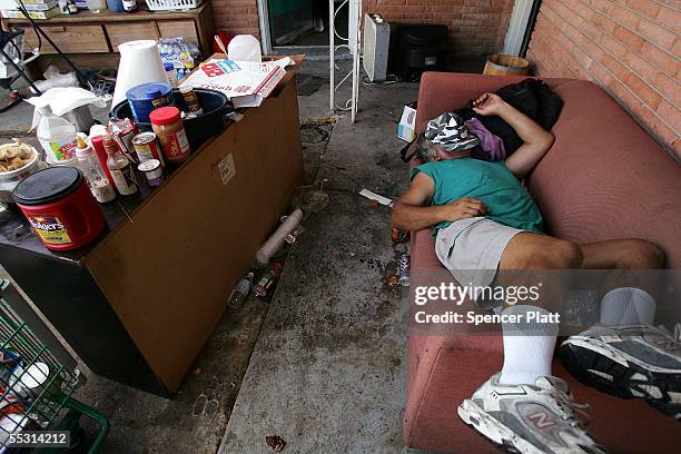 David Bourgeois, who nearly drowned during Hurricane Katrina, sleeps in the parking lot of a ruined hotel which is now his home September 7, 2005 in...