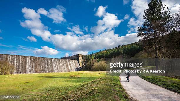 cyclist in the upper derwent valley, derbyshire - derwent reservoir stock pictures, royalty-free photos & images