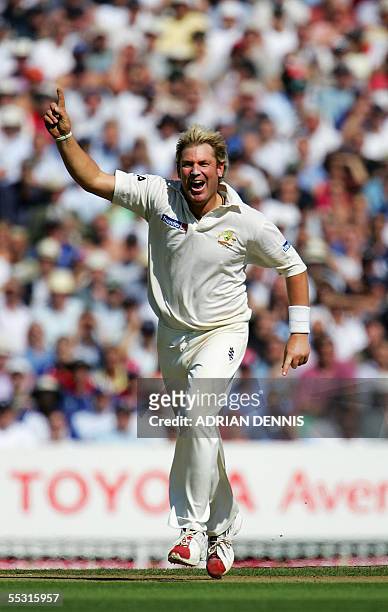 London, UNITED KINGDOM: Australia's spin bowler Shane Warne celebrates after taking the wicket of England's Captain Michael Vaughan during the first...