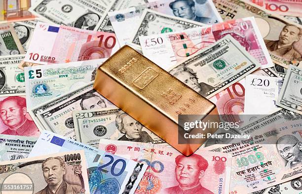 gold ingot and bank notes - gold bullion stock pictures, royalty-free photos & images