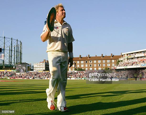 Shane Warne of Australia acknowledges the crowd at the close of play after his five wickets during day one of the Fifth npower Ashes Test between...