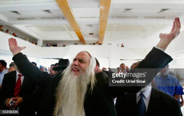 Rabbis and former Jewish settlers pray for the last time in a synagogue in what used to be the Jewish settlement of Neve Dekalim September 8, 2005 in...