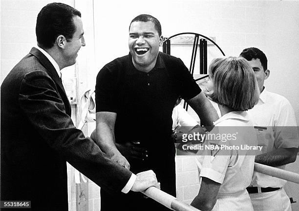 Maurice Stokes, right, of the Cincinnati Royals enjoys a light moment with teammate Jack Twyman, left, while going through physical therapy in 1958....