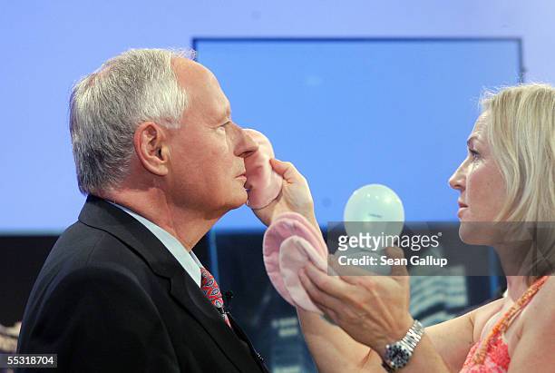 Linkspartei political party co-lead candidate Oskar Lafontaine receives last-minute make-up shortly before appearing with FDP political party lead...