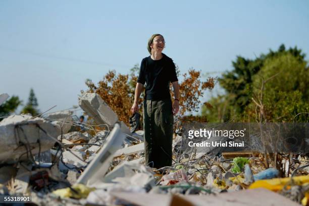 An Israeli settler pick through the rubble that was their home in the former Jewish settlement of Neve Dekalim on September 8, 2005 in the Gaza...