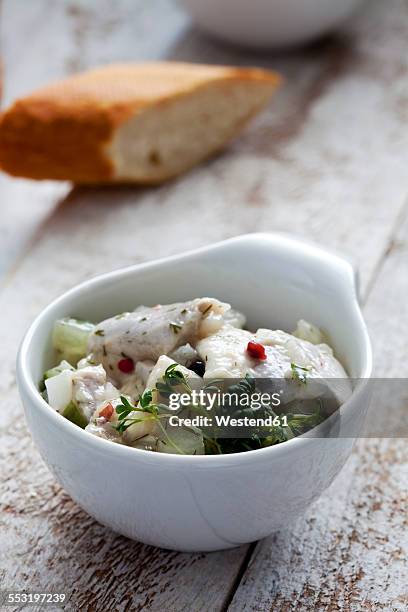 bowl of pickled herring salad with cress - arenque fotografías e imágenes de stock