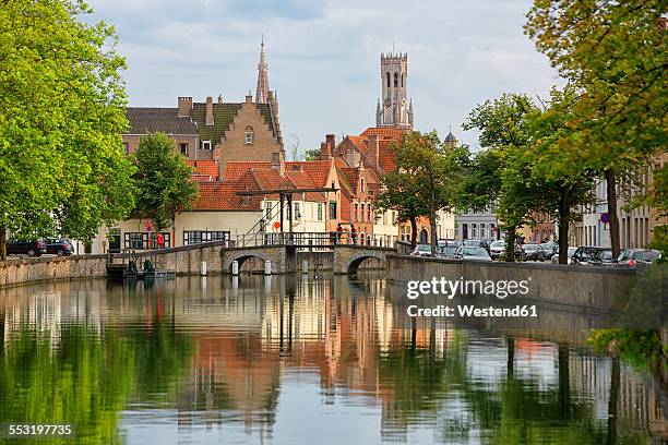 belgium, bruges, churches reflecting in canals - belgium canal stockfoto's en -beelden