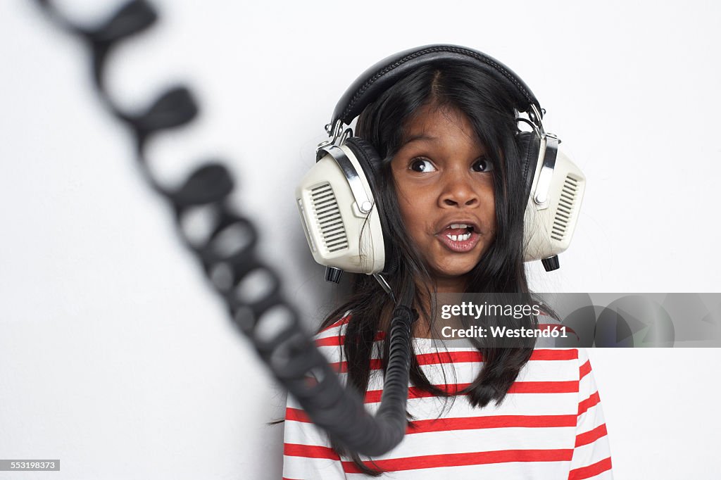 Portrait of girl hearing music with headphones