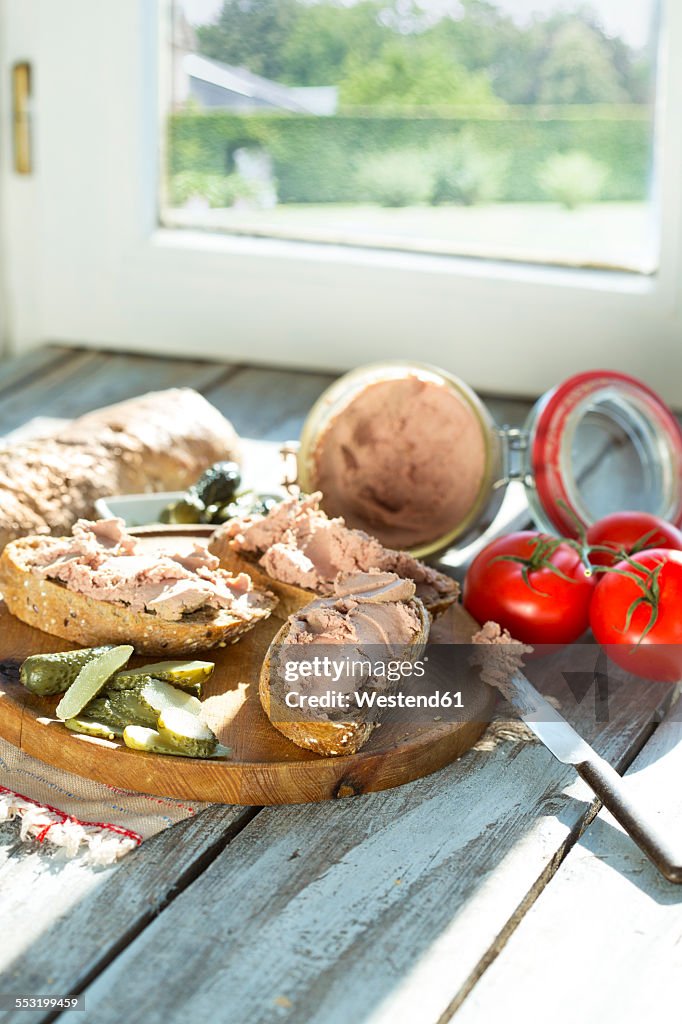 Liverwurst spread with pickled cucumber and tomatoes