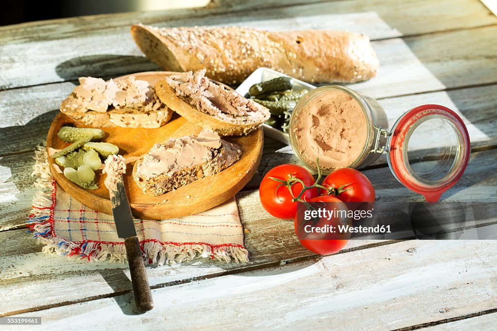 Liverwurst spread with pickled cucumber and tomatoes