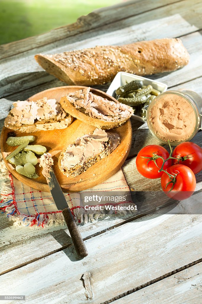Liverwurst spread with pickled cucumber and tomatoes