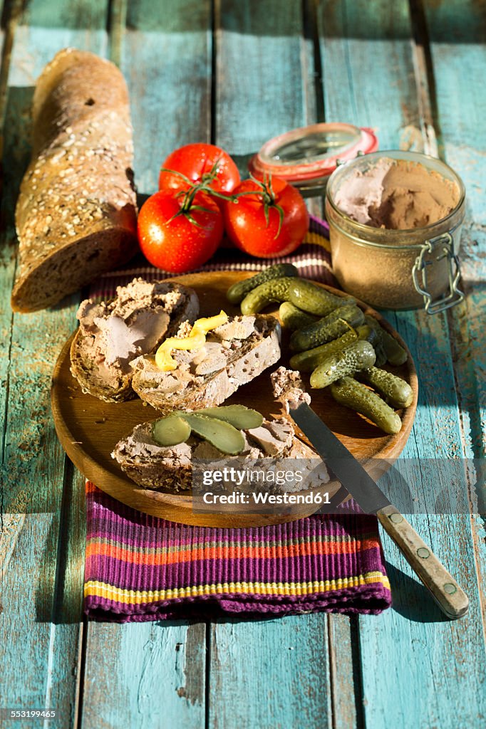 Liverwurst spread with pickled cucumber and tomatoes
