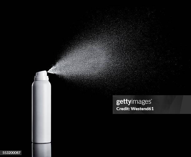white spraying aerosol can in front of black background - sprühdose stock-fotos und bilder