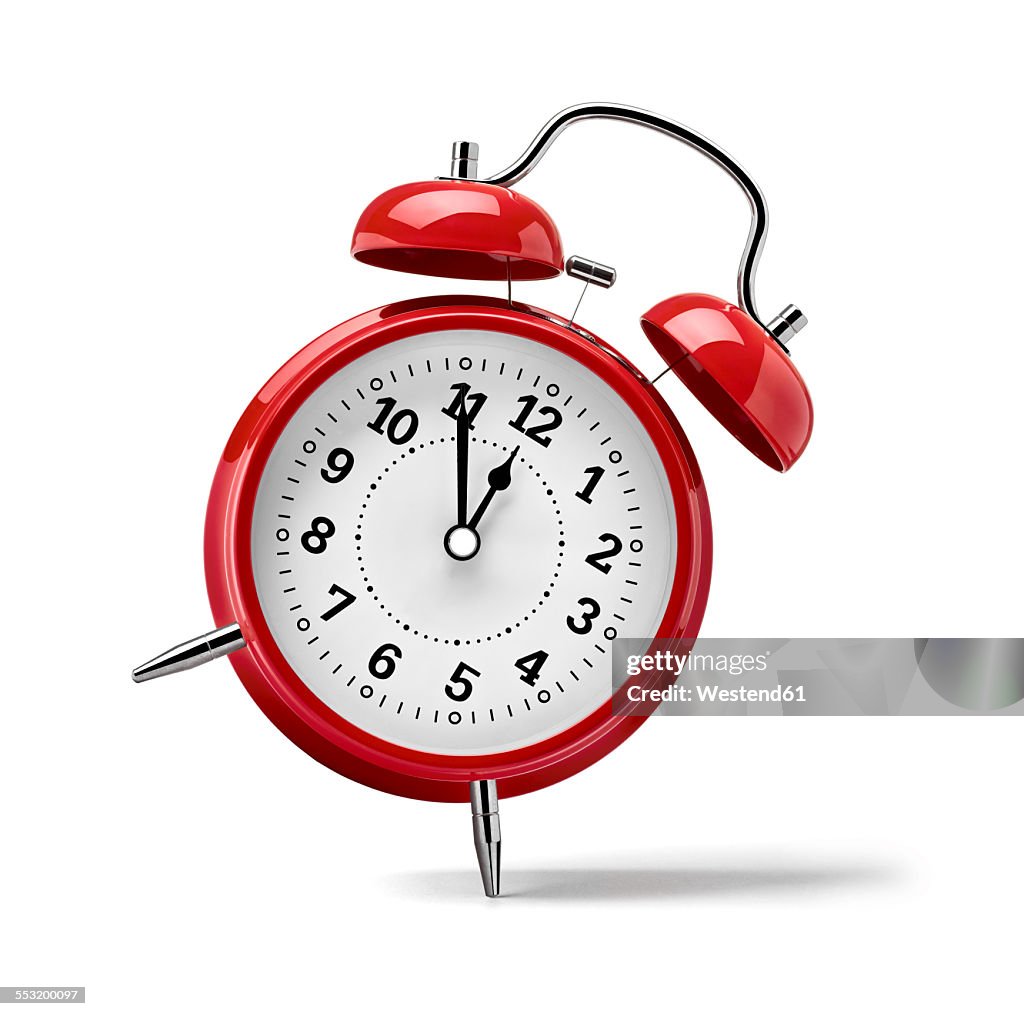 Red clock in front of white background