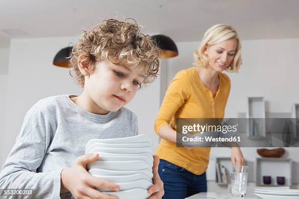 mother and son laying the table - setting the table stock pictures, royalty-free photos & images