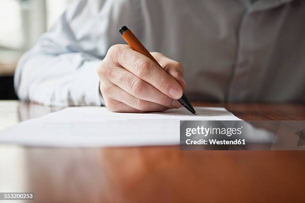 man signing document - handwriting paper stock pictures, royalty-free photos & images