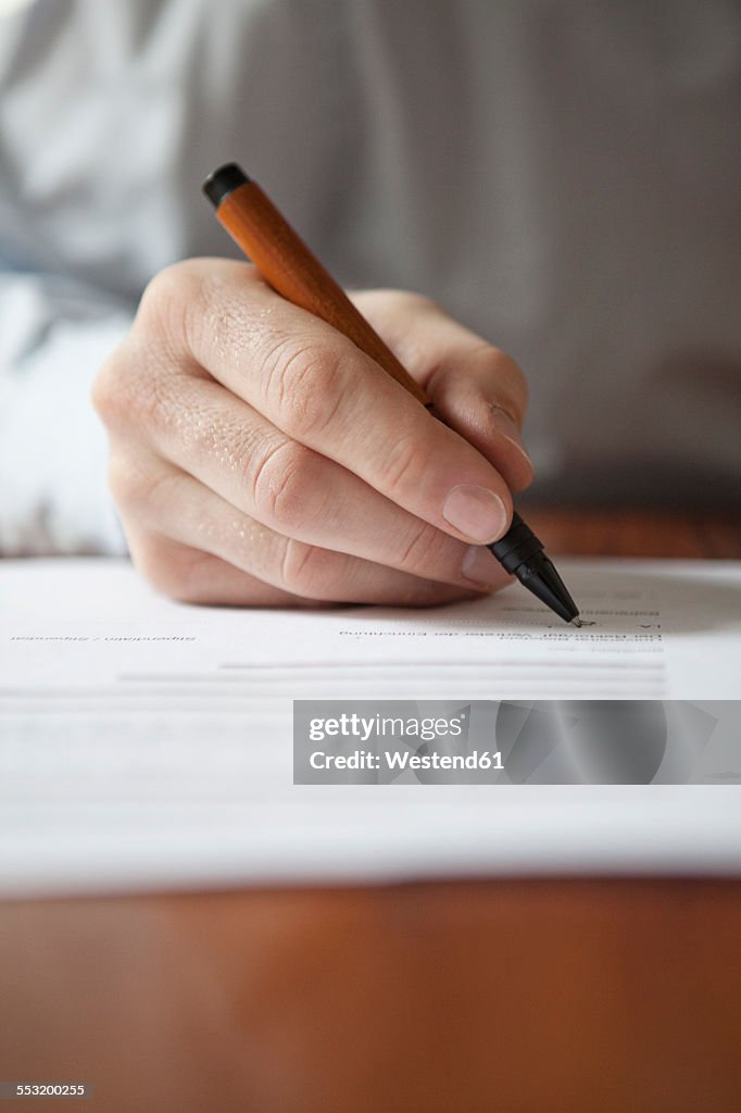 Man signing document