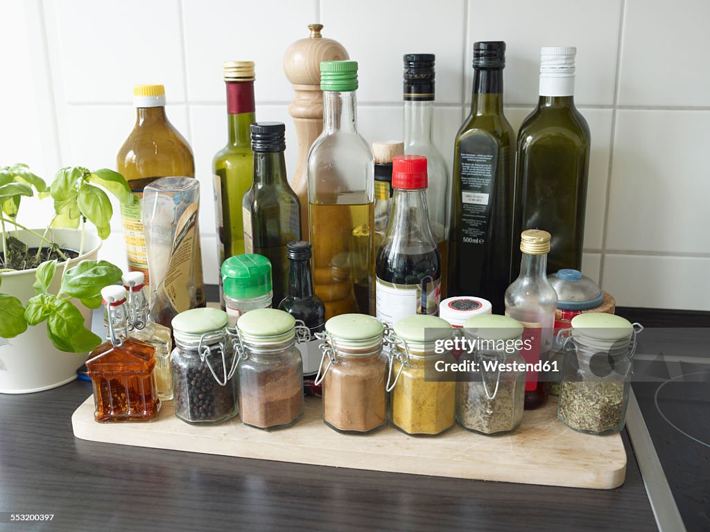 Glasses with herbs and spices in kitchen