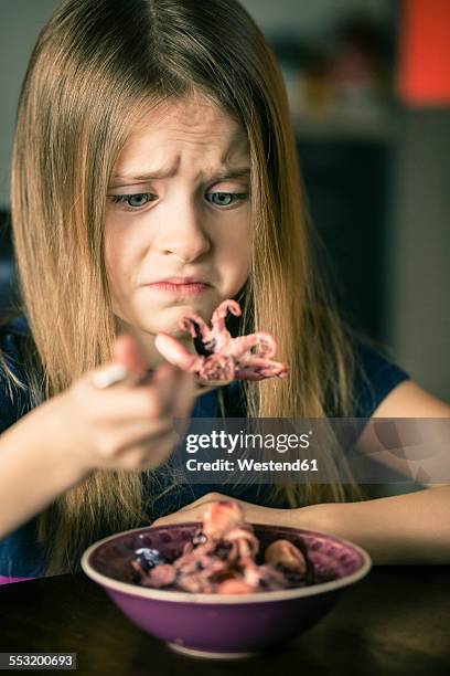 portrait of unhappy girl with bowl of squids - octopus girl foto e immagini stock