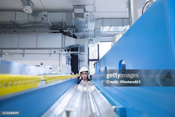 technician in factory hall - symmetry imagens e fotografias de stock