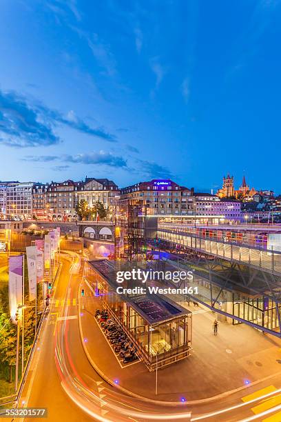 switzerland, lausanne, traffic in the city at dusk - lausanne cathedral notre dame stock pictures, royalty-free photos & images