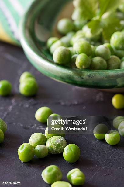 frozen peas on slate - frozen vegetables stock pictures, royalty-free photos & images