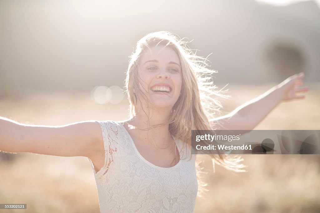 South Africa, Happy young woman dancing in field