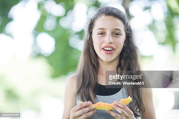 portrait of girl eating a melon - rockmelon stock pictures, royalty-free photos & images