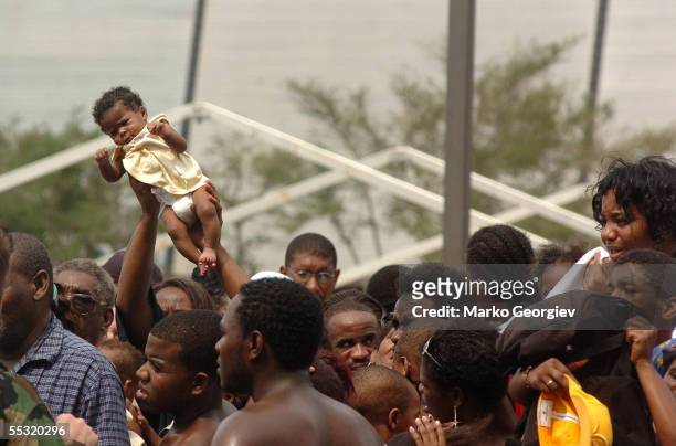 Baby gets lifted up from the crowd of people waiting to be evacuated from the New Orleans Super Dome on September 1, 2005 in New Orleans, Louisiana....