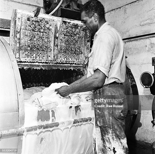 View of a worker manning an industrial washing machine used to clean cloth diapers by the Crib Diaper Service, Long Island, New York, June 1947.