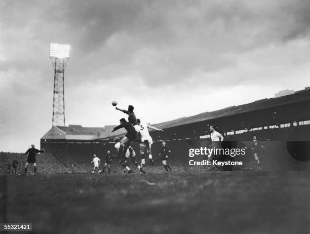 Manchester United keeper Harry Gregg punches a ball clear after an attack on goal during a match against AC Milan in the first leg of the European...